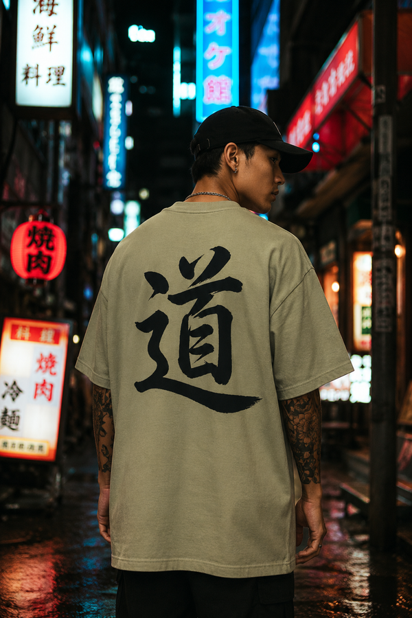 道 'The Way' calligraphy tee in sage green, back view in a neon alley